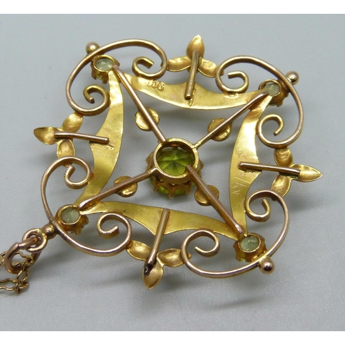 1050 - A 9ct gold pendant set with peridot and half seed pearls on a 9ct gold chain, 5.1g, 36cm