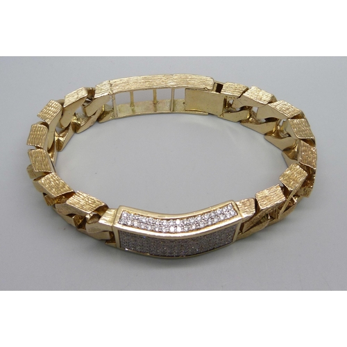 1058 - A heavy 9ct gold curb linked ID bracelet with bark effect texture, set with 3.4ct of diamonds, round... 