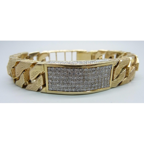 1058 - A heavy 9ct gold curb linked ID bracelet with bark effect texture, set with 3.4ct of diamonds, round... 