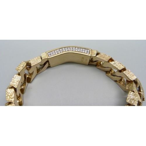 1058 - A heavy 9ct gold curb linked ID bracelet with bark effect texture, set with 3.4ct of diamonds, round... 