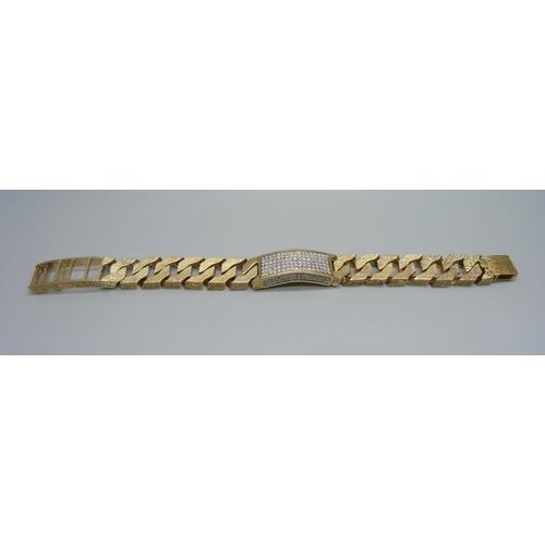 1058 - A heavy 9ct gold curb linked ID bracelet with bark effect texture, set with 3.4ct of diamonds, round... 