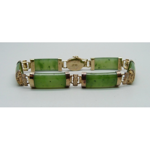 1064 - A silver gilt and jade bracelet