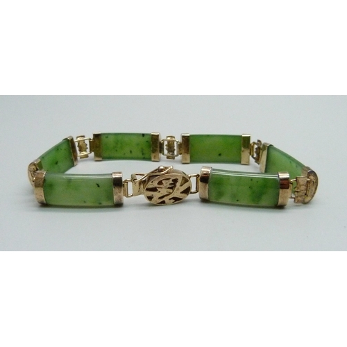 1064 - A silver gilt and jade bracelet