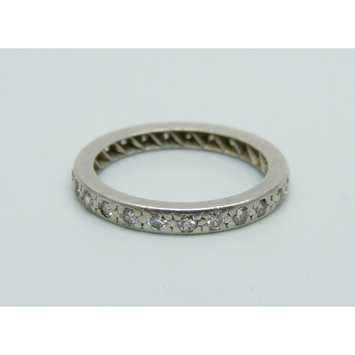 1068 - A white metal and diamond eternity ring, 3.2g, L