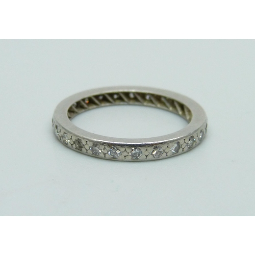 1068 - A white metal and diamond eternity ring, 3.2g, L