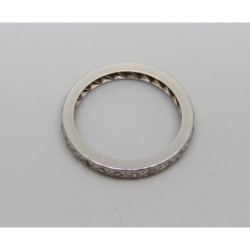 1068 - A white metal and diamond eternity ring, 3.2g, L