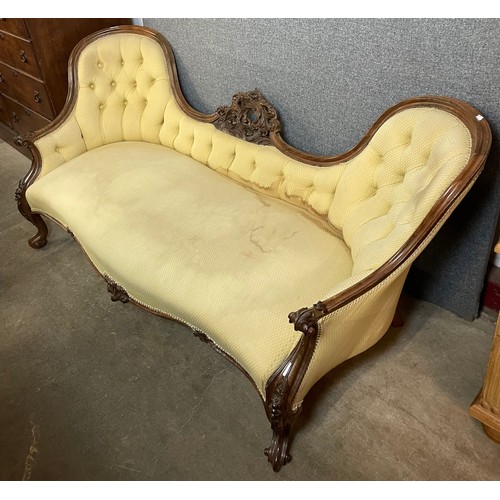 123 - An Victorian carved mahogany and fabric upholstered twin spoon back settee