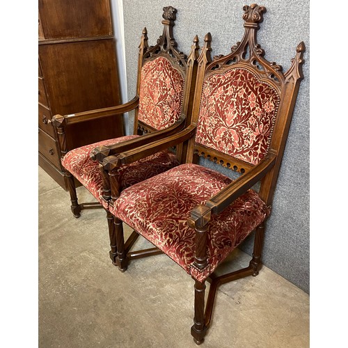 125 - A pair of similar Victorian Gothic Revival carved oak throne chairs