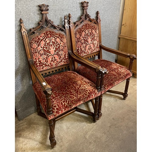 125 - A pair of similar Victorian Gothic Revival carved oak throne chairs