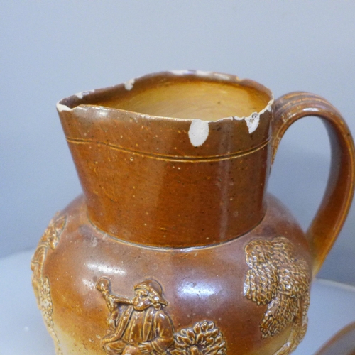 613 - Two lidded Victorian saltglaze jugs, one engraved with a lion and inscribed 