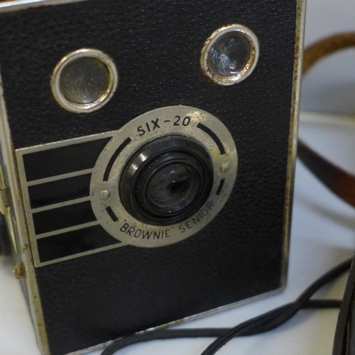 615 - A Brownie box camera, one other Paxette and a light meter