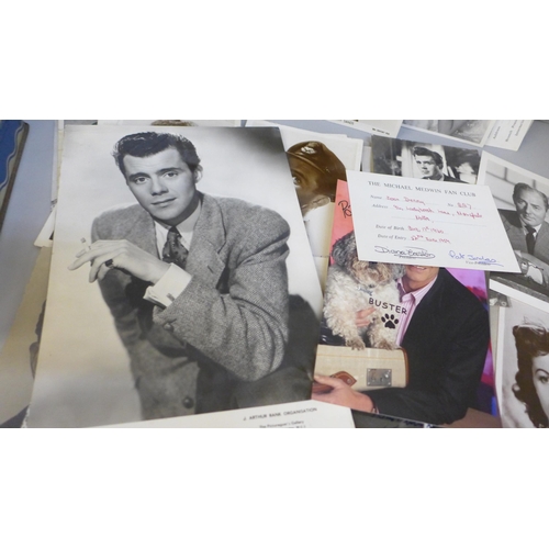 617 - A tin containing celebrity photographs and postcards, many with facsimile autographs including Dirk ... 