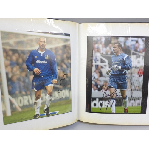 668 - An album of signed football photographs, Premier League and earlier playing legends, 40 in total, in... 