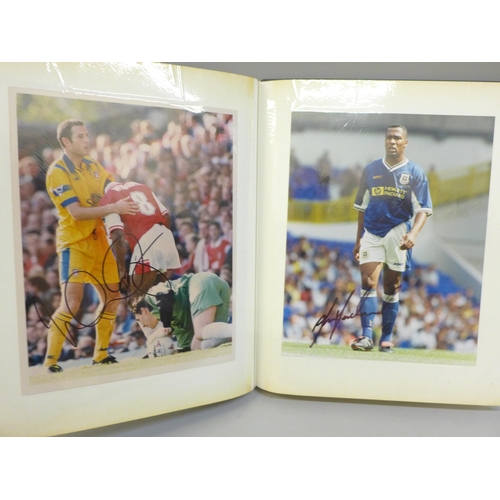 668 - An album of signed football photographs, Premier League and earlier playing legends, 40 in total, in... 