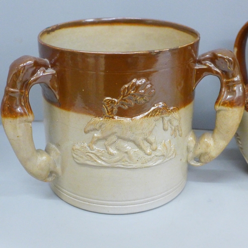 730 - A Victorian saltglaze tyg with three greyhound handles, a hunting jug and mug (3)