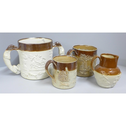 831 - A Denby Victorian saltglaze loving cup, two mugs and a jug - two with old staple repairs (4)