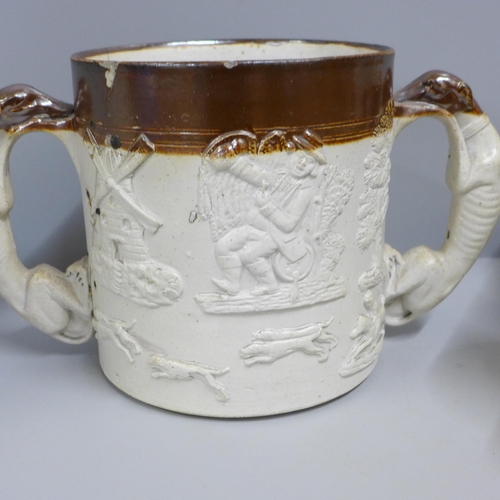 831 - A Denby Victorian saltglaze loving cup, two mugs and a jug - two with old staple repairs (4)