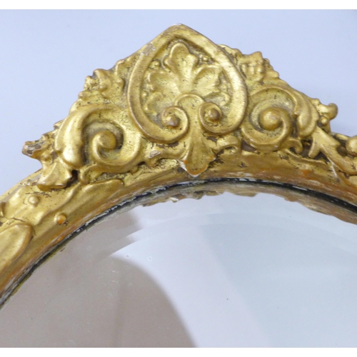 835 - A gilt framed oval wall mirror, 30cm wide