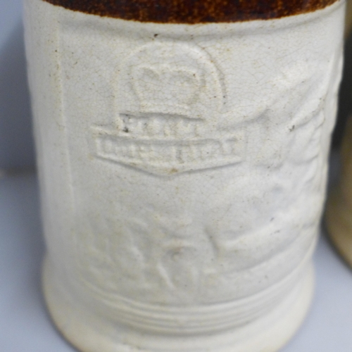 842 - Two Victorian saltglaze small jugs one with cherubs and three Imperial pint mugs and one ½ pint mug ... 