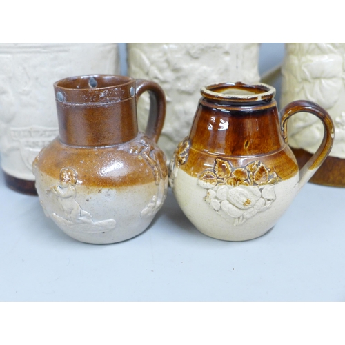 842 - Two Victorian saltglaze small jugs one with cherubs and three Imperial pint mugs and one ½ pint mug ... 