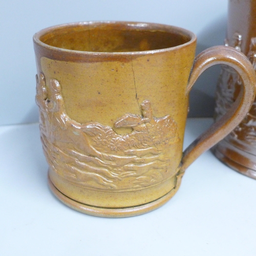 845 - A Victorian Brampton saltglaze jug, two mugs and a tobacco jar with a dog to lid, a/f (4)