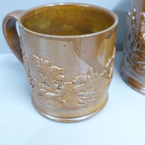 845 - A Victorian Brampton saltglaze jug, two mugs and a tobacco jar with a dog to lid, a/f (4)