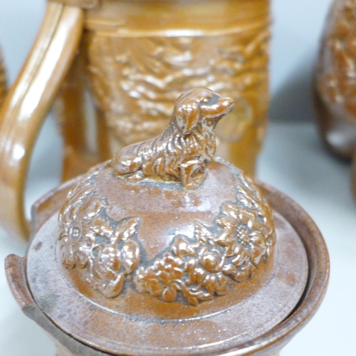 845 - A Victorian Brampton saltglaze jug, two mugs and a tobacco jar with a dog to lid, a/f (4)