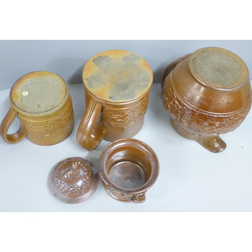 845 - A Victorian Brampton saltglaze jug, two mugs and a tobacco jar with a dog to lid, a/f (4)