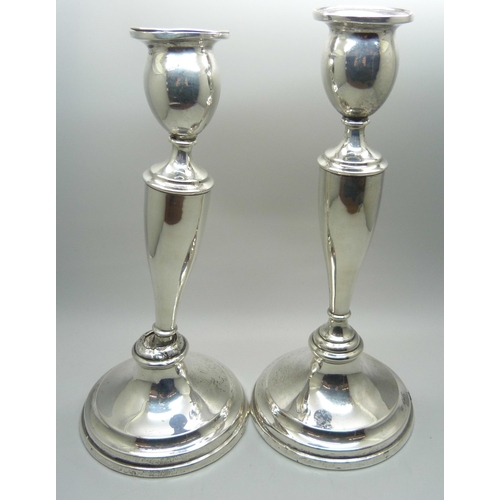 866 - A pair of silver candlesticks, weighted bases, one a/f