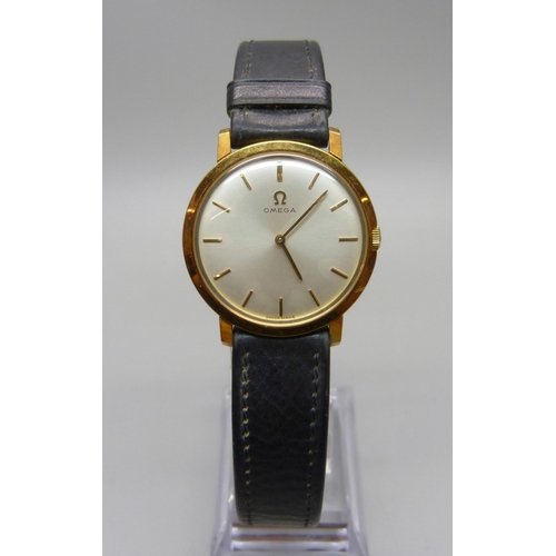 869 - An Omega wristwatch with a leather strap and gold plated Omega buckle, boxed and with paperwork, 31m... 