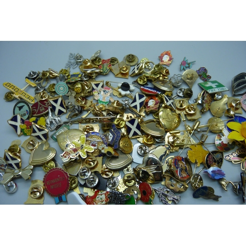 908 - A collection of assorted pin badges and a collection of stick pins