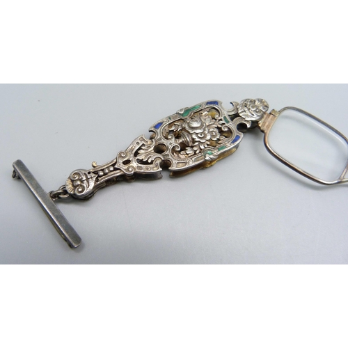 956 - A pair of decorative enamelled lorgnettes suspended on a silver bar brooch, enamel a/f