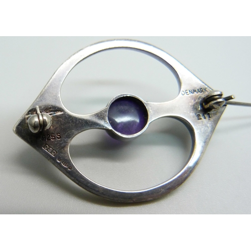 961 - A Danish Arne Johansen 211 brooch with Hans Hansen signature, set with a cabochon amethyst, London i... 