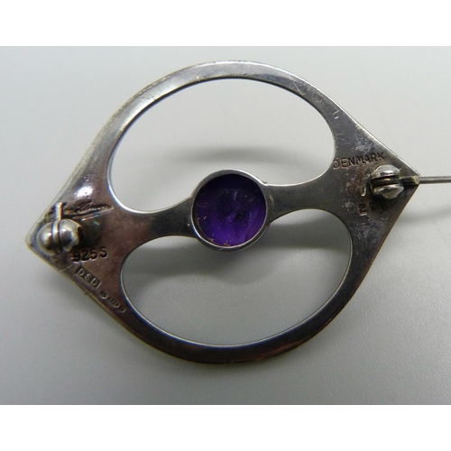 961 - A Danish Arne Johansen 211 brooch with Hans Hansen signature, set with a cabochon amethyst, London i... 