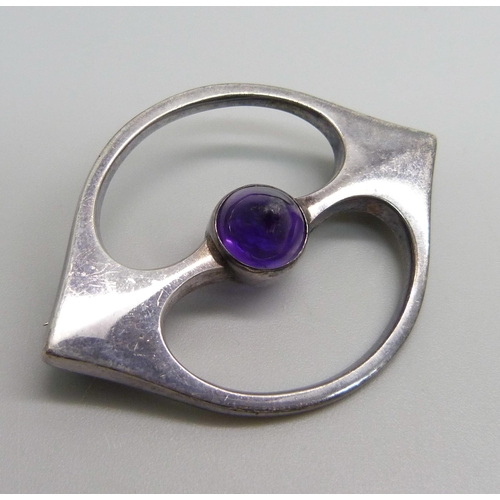 961 - A Danish Arne Johansen 211 brooch with Hans Hansen signature, set with a cabochon amethyst, London i... 