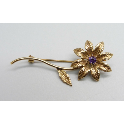 962 - A 9ct gold flower brooch set with an amethyst, 4.3g, 55mm