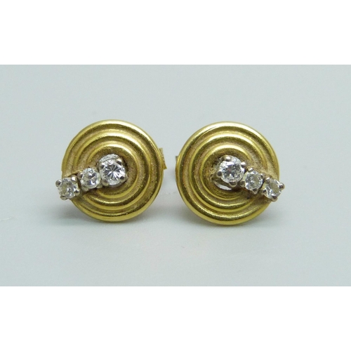 973 - A pair of 18ct gold and diamond set stud earrings, 2.5g