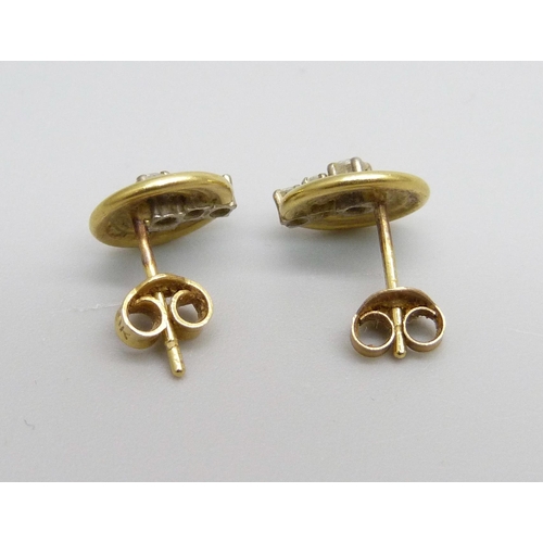 973 - A pair of 18ct gold and diamond set stud earrings, 2.5g