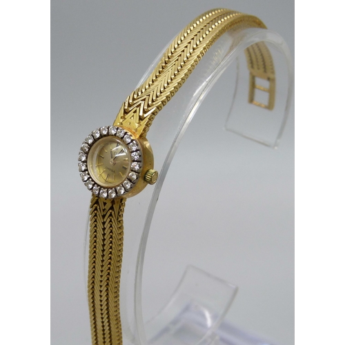 974 - A lady's 18ct gold Omega cocktail wristwatch with diamond bezel and integrated herringbone link brac... 