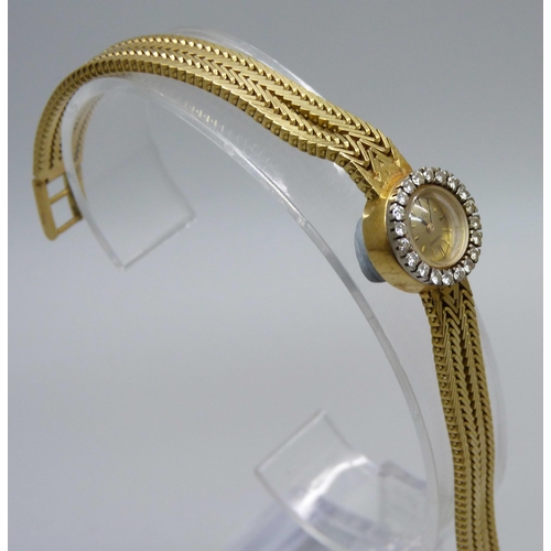 974 - A lady's 18ct gold Omega cocktail wristwatch with diamond bezel and integrated herringbone link brac... 