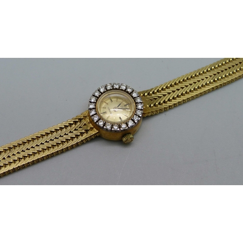 974 - A lady's 18ct gold Omega cocktail wristwatch with diamond bezel and integrated herringbone link brac... 