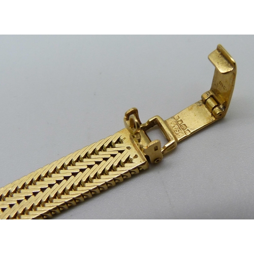 974 - A lady's 18ct gold Omega cocktail wristwatch with diamond bezel and integrated herringbone link brac... 