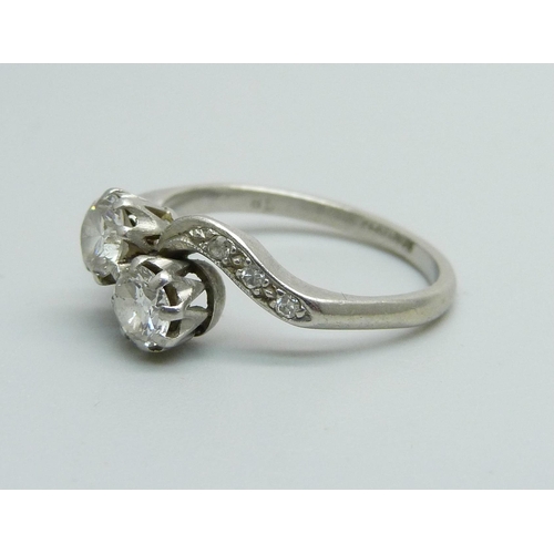 991 - An Art Deco platinum and two stone diamond ring, each approximately ½ carat weight, with diamond sho... 