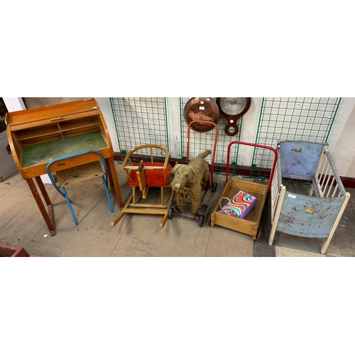331 - A child's roll top desk and chair, a cot, a child's rocking horse and a baby walker