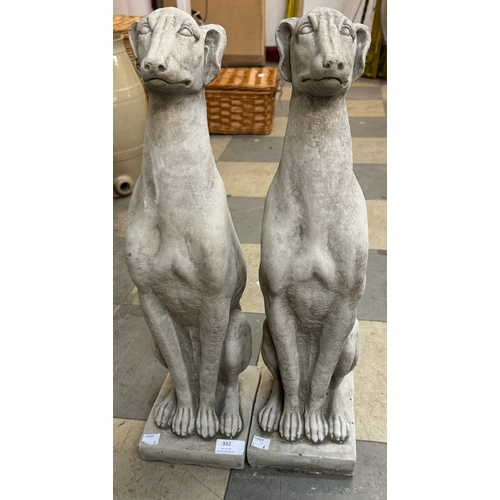 332 - A pair of concrete garden figures of seated greyhounds