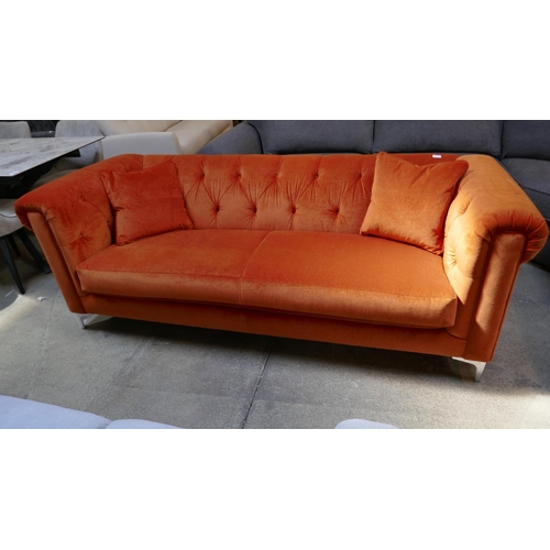 1522 - A tangerine velvet buttoned three seater sofa