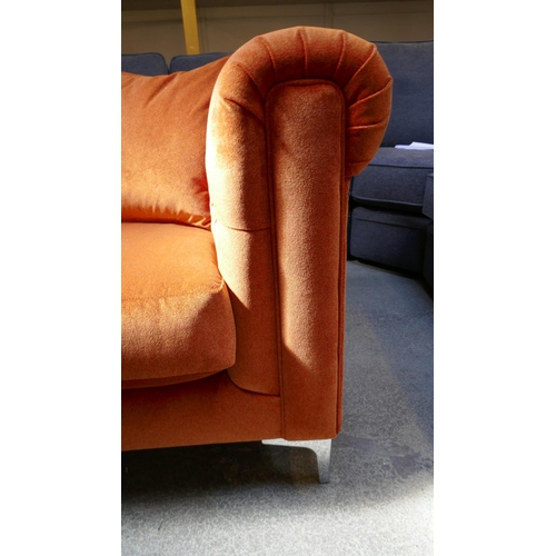 1522 - A tangerine velvet buttoned three seater sofa