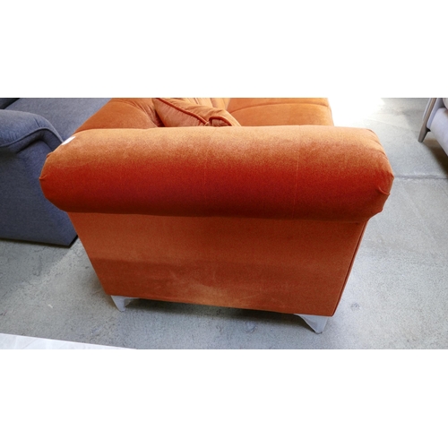 1522 - A tangerine velvet buttoned three seater sofa