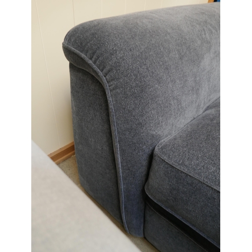 1525 - A deep blue upholstered three seater sofa