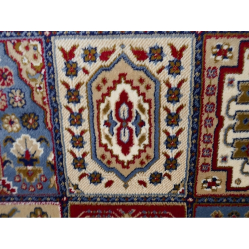 1532 - A large full pile cashmere carpet, traditional Persian panel design, 380cm x 280cm